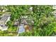 Aerial view of a home showcasing mature trees, fenced yard, and new driveway at 2106 W Saint Isabel St, Tampa, FL 33607