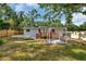 Backyard featuring a gazebo, deck, and mature landscaping for outdoor enjoyment at 2106 W Saint Isabel St, Tampa, FL 33607