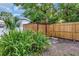 View of a fenced backyard featuring a storage shed and lush greenery at 2106 W Saint Isabel St, Tampa, FL 33607