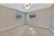 Light-filled bedroom with tile floors, ceiling fan, and bright windows at 2106 W Saint Isabel St, Tampa, FL 33607