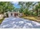 An inviting home featuring a long driveway, well-maintained lawn, and freshly painted exterior at 2106 W Saint Isabel St, Tampa, FL 33607
