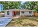 Charming single-story home with a well-manicured lawn, a bright red front door, and a welcoming entrance at 2106 W Saint Isabel St, Tampa, FL 33607