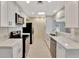 Modern kitchen features white cabinets, stainless steel appliances, and marble countertops at 2106 W Saint Isabel St, Tampa, FL 33607