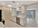 Bright kitchen featuring white cabinets, stainless steel appliances, and a view to the deck at 2106 W Saint Isabel St, Tampa, FL 33607