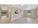 Open living space with tile floors, view to kitchen, and natural light from large windows at 2106 W Saint Isabel St, Tampa, FL 33607