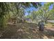 Expansive backyard featuring mature trees, a storage shed, a grill and hammock, offering a serene outdoor space at 249 41St Ne Ave, St Petersburg, FL 33703