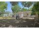 Backyard featuring mature trees, hammock and grill, fenced for privacy at 249 41St Ne Ave, St Petersburg, FL 33703