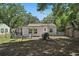 Private backyard with mature trees, hammock, and grill at 249 41St Ne Ave, St Petersburg, FL 33703