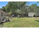 Large backyard featuring a lawn, shed, and patio space at 249 41St Ne Ave, St Petersburg, FL 33703