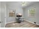 Cozy bedroom with modern flooring, ceiling fan, and natural light from two windows at 249 41St Ne Ave, St Petersburg, FL 33703