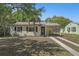 Charming single-story home with a driveway and manicured lawn, creating a welcoming curb appeal at 249 41St Ne Ave, St Petersburg, FL 33703