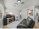Modern living room featuring a leather sofa, large TV, contemporary lighting, and tile floors at 249 41St Ne Ave, St Petersburg, FL 33703