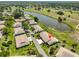 This is an aerial view of a home on a large lot with a lake in the backyard at 2509 Locksley St # 237, Sun City Center, FL 33573