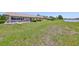 Spacious backyard featuring lush grass, landscaping, and waterfront views at 2509 Locksley St # 237, Sun City Center, FL 33573