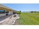 The backyard has lush landscaping and a tranquil lake view from the patio at 2509 Locksley St # 237, Sun City Center, FL 33573