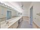 Bright bathroom with dual sinks, vanity, and a large mirror creating an open and functional space at 2509 Locksley St # 237, Sun City Center, FL 33573