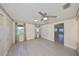 Bright bedroom with light gray tile flooring, ceiling fan, windows, and closet space at 2509 Locksley St # 237, Sun City Center, FL 33573