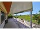 The covered patio features decorative landscaping and a tranquil view of the lake at 2509 Locksley St # 237, Sun City Center, FL 33573