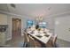 Staged dining room with a marble table, seating for six, and modern chandelier at 2509 Locksley St # 237, Sun City Center, FL 33573