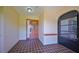 Covered front entry with tile flooring, decorative sidelight, and stylish front door at 2509 Locksley St # 237, Sun City Center, FL 33573