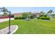 Beautifully landscaped front yard featuring lush green grass and manicured shrubs at 2509 Locksley St # 237, Sun City Center, FL 33573
