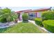 Charming single-story home features manicured landscaping, decorative stone, and lush green grass at 2509 Locksley St # 237, Sun City Center, FL 33573