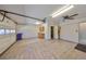 Spacious garage with an overhead door, utility sink and side entrance providing secure parking and storage at 2509 Locksley St # 237, Sun City Center, FL 33573