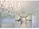 This stunning kitchen with modern appliances and a unique chandelier in the view to the living room at 2509 Locksley St # 237, Sun City Center, FL 33573