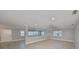 Open living space featuring wood-look tile, gray walls, and plantation shutters for natural light at 2509 Locksley St # 237, Sun City Center, FL 33573