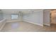 Large living room featuring tiled floors, crown molding, a ceiling fan, and a bright window at 2509 Locksley St # 237, Sun City Center, FL 33573