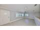 Bright, open living room with plank flooring, neutral paint, and ample natural light at 2509 Locksley St # 237, Sun City Center, FL 33573