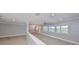 Bright living room featuring large windows, neutral walls and floors, and a modern ceiling fan at 2509 Locksley St # 237, Sun City Center, FL 33573