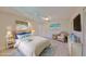 Staged main bedroom featuring a ceiling fan, cozy seating, and ample natural light at 2509 Locksley St # 237, Sun City Center, FL 33573