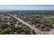 Distant aerial view showcases homes nestled amongst mature trees and a nearby thoroughfare at 2693 Sabal Springs Cir # 206, Clearwater, FL 33761