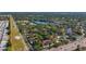 An aerial view showcases a community featuring single-Gathering homes and a townhouse complex with private pool and pond access at 2693 Sabal Springs Cir # 206, Clearwater, FL 33761