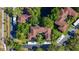 Aerial view shows building's layout with lots of trees and parking at 2693 Sabal Springs Cir # 206, Clearwater, FL 33761