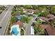 Aerial view showcases community pool, tennis courts, and lush landscaping near a busy thoroughfare at 2693 Sabal Springs Cir # 206, Clearwater, FL 33761