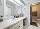 Bright bathroom with a large vanity area with a view to the shower and toilet at 2693 Sabal Springs Cir # 206, Clearwater, FL 33761