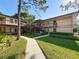 Inviting condo exterior featuring lush landscaping and a well-maintained building facade at 2693 Sabal Springs Cir # 206, Clearwater, FL 33761