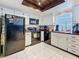 Well-lit kitchen features white cabinets, dark countertops, and black appliances at 2693 Sabal Springs Cir # 206, Clearwater, FL 33761