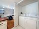 Laundry room with washer and dryer hookups, featuring hardwood floors and white tiled floors at 2693 Sabal Springs Cir # 206, Clearwater, FL 33761