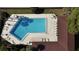 Aerial shot of a community pool with lounge chairs and tables available for resident use at 2693 Sabal Springs Cir # 206, Clearwater, FL 33761