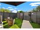 Cozy backyard with artificial turf, string lights, modern fence, and inviting outdoor seating at 2810 N Florida Ave, Tampa, FL 33602