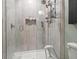 Updated shower featuring modern fixtures, convenient shelving, and sleek glass enclosure at 2810 N Florida Ave, Tampa, FL 33602