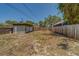 Spacious backyard featuring a wooden fence and a detached garage, offering privacy and potential at 2835 Dartmouth N Ave, St Petersburg, FL 33713