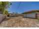 Property's backyard featuring a privacy fence, detached garage, and ample space for outdoor activities and landscaping at 2835 Dartmouth N Ave, St Petersburg, FL 33713