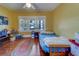 Bright bedroom with hardwood floors, three windows, and a ceiling fan at 2835 Dartmouth N Ave, St Petersburg, FL 33713