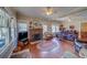 Inviting living room with a brick fireplace, hardwood floors, and plenty of natural light at 2835 Dartmouth N Ave, St Petersburg, FL 33713