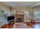Inviting living room featuring a brick fireplace, hardwood floors, and cozy seating at 2835 Dartmouth N Ave, St Petersburg, FL 33713