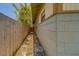 Narrow side yard with wooden fence, providing a private walkway and potential for landscaping at 2835 Dartmouth N Ave, St Petersburg, FL 33713